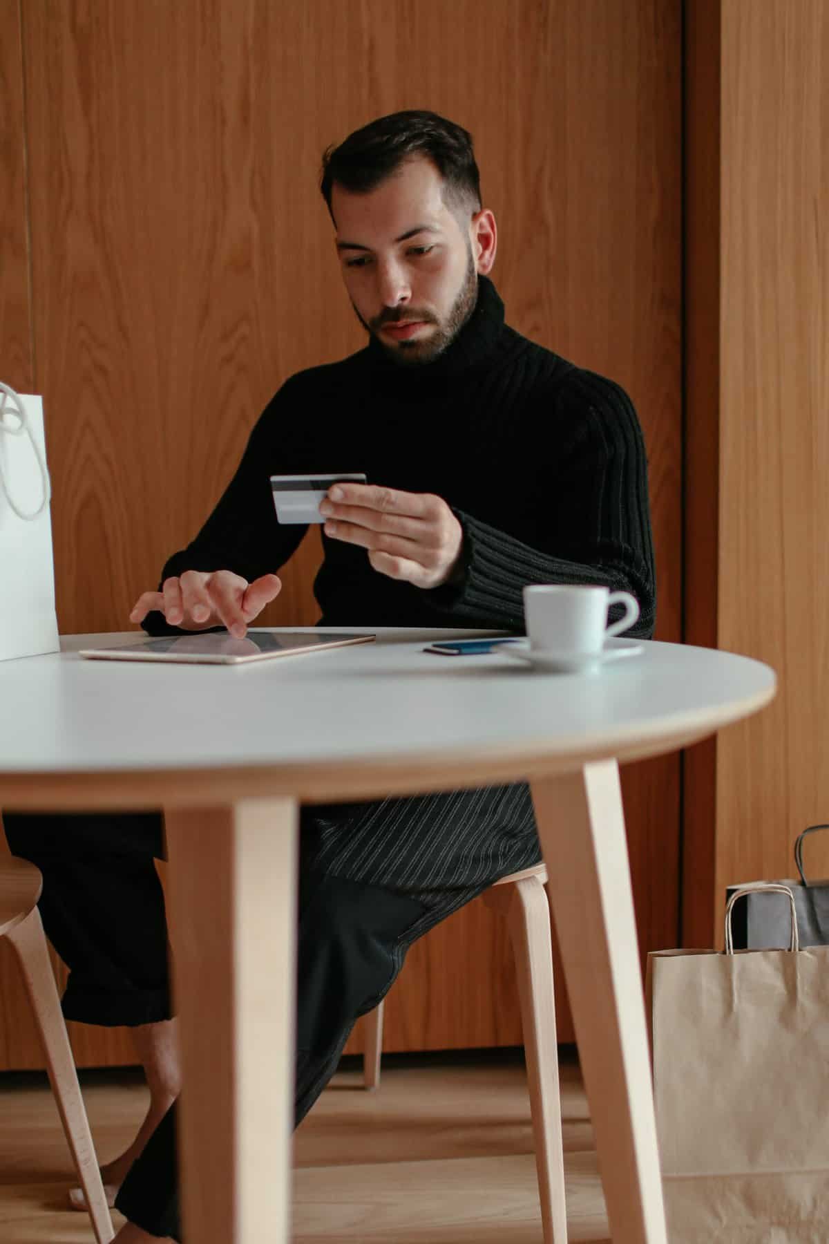 man sitting looking at a card